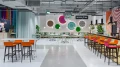 Symmetrical view of Helga's Bar featuring wall graphics and seating areas on both sides.